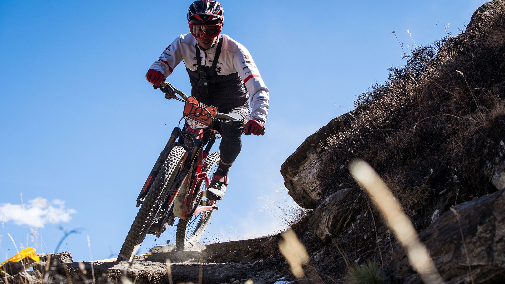 Gabriel Amigo jumping a rock against a blue sky